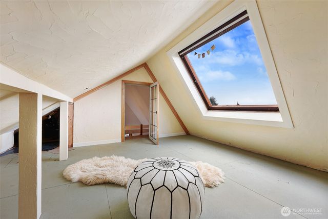 a spacious bedroom with a bed and a couch