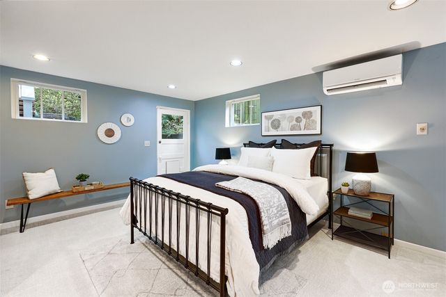 a bedroom with a bed and a large mirror
