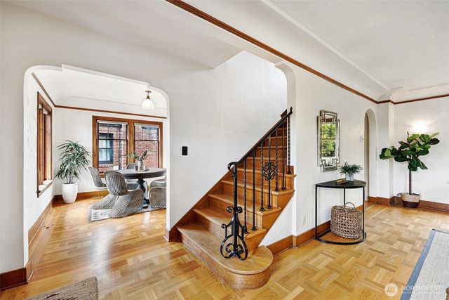 a view of staircase with furniture and a potted plant