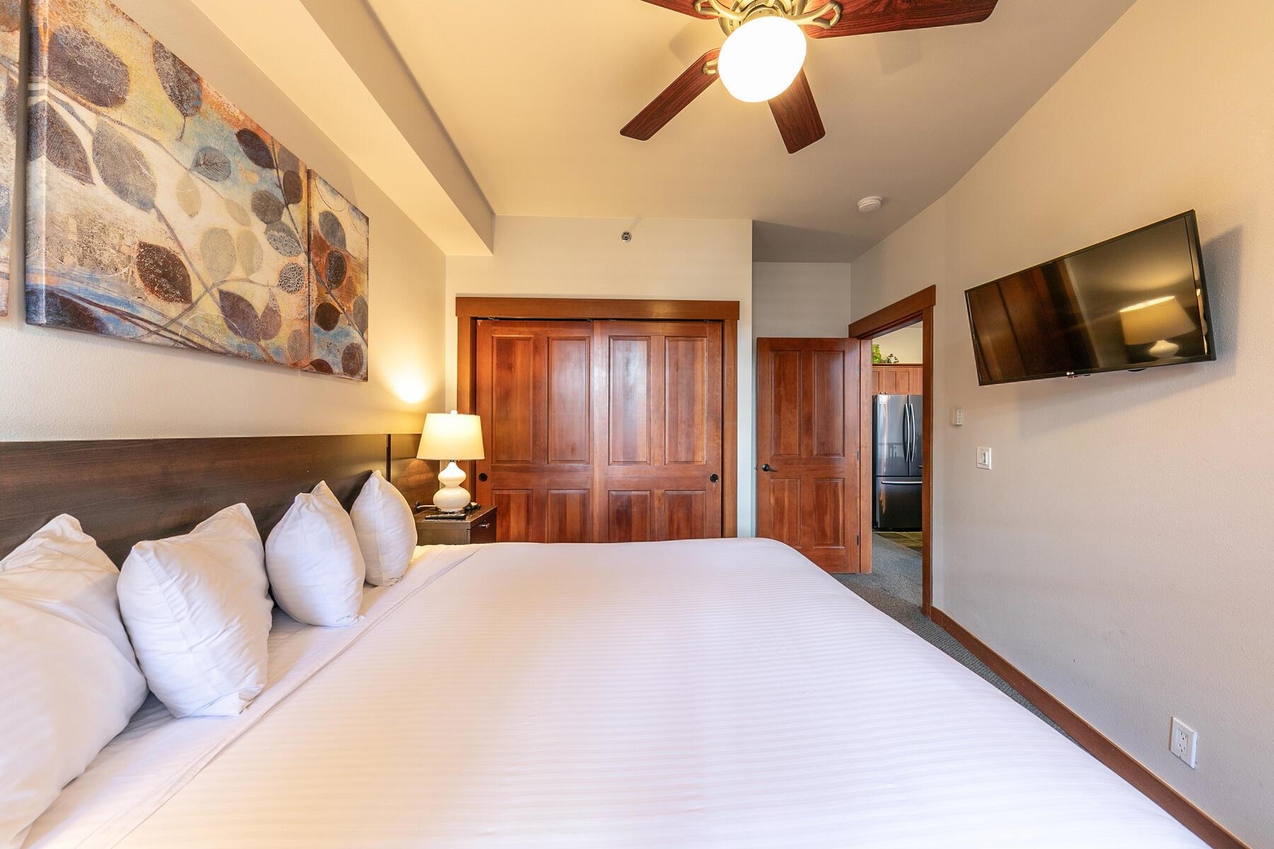 1750 Village East Road, Unit 5418 Olympic Valley, CA 96146 - Photo 14 of 21 a bedroom with a large bed and a flat tv screen on a dresser