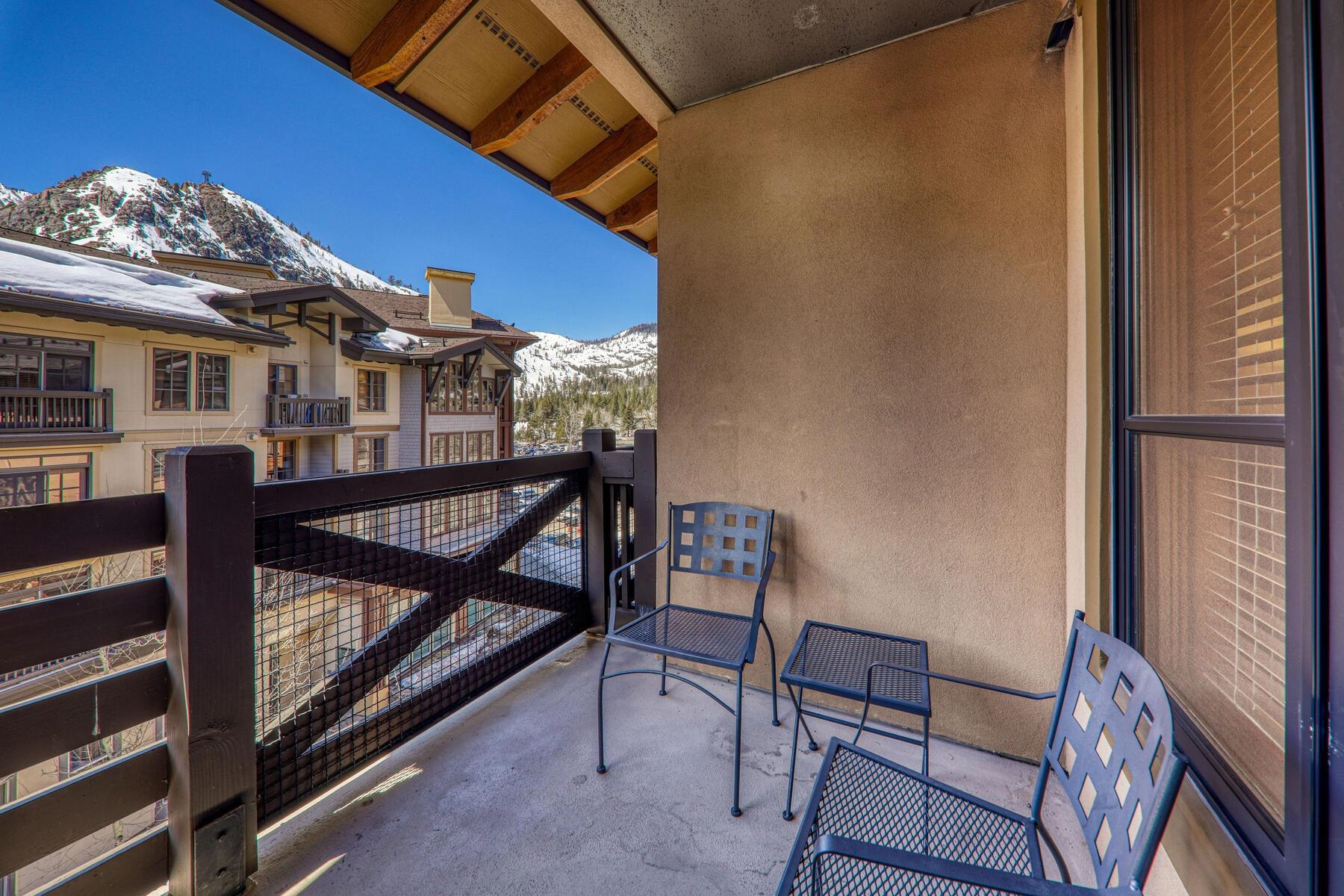 1750 Village East Road, Unit 5418 Olympic Valley, CA 96146 - Photo 19 of 21 a view of a balcony with furniture and a red umbrella