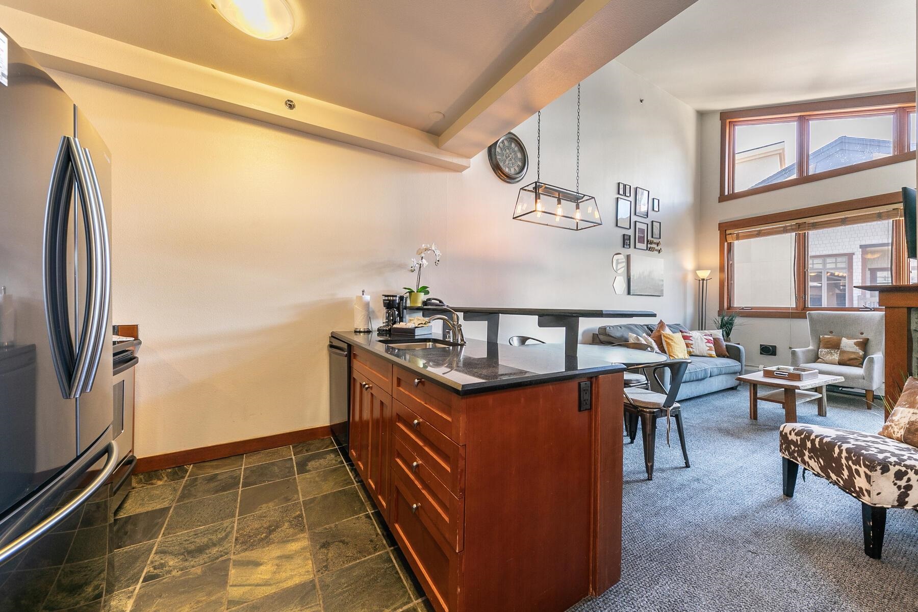 1750 Village East Road, Unit 5418 Olympic Valley, CA 96146 - Photo 9 of 21 a kitchen with stainless steel appliances granite countertop a sink and a refrigerator