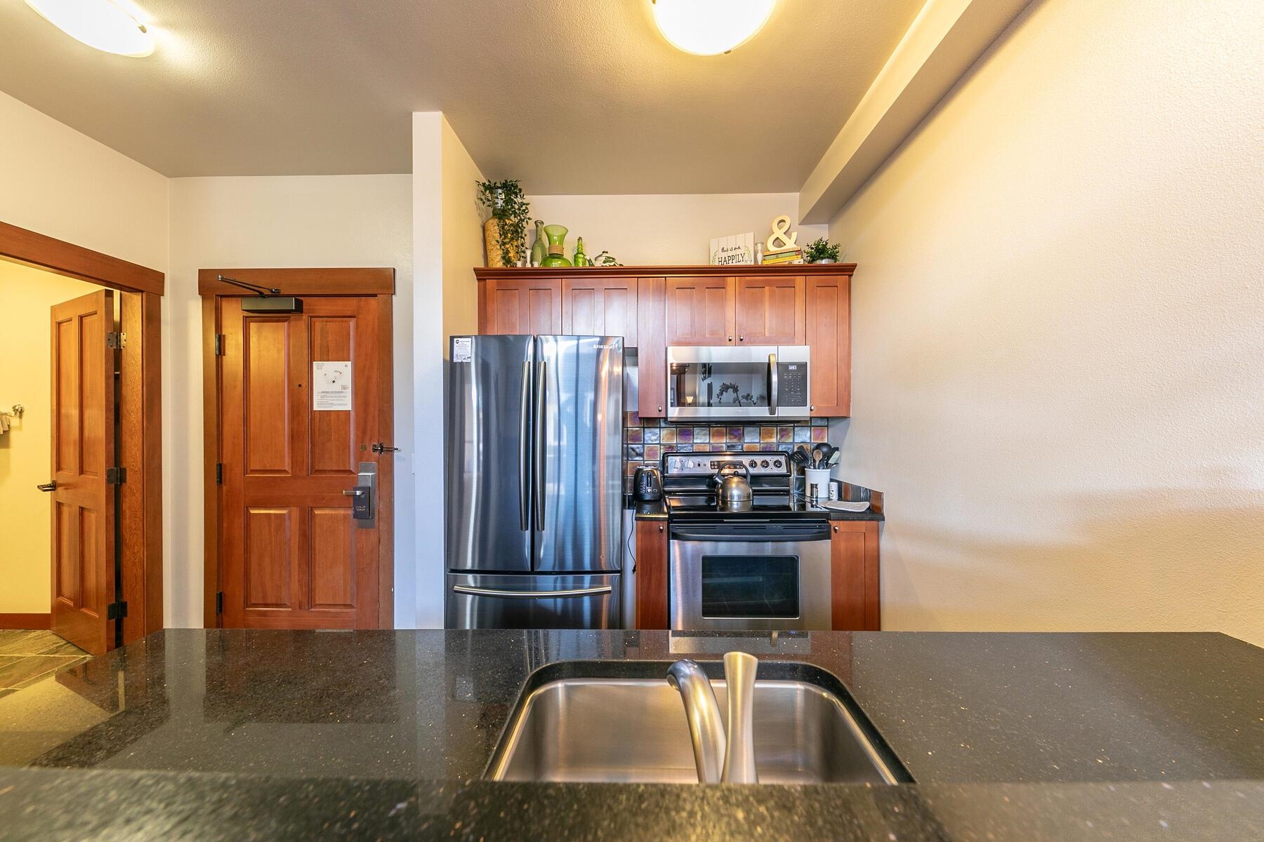 1750 Village East Road, Unit 5418 Olympic Valley, CA 96146 - Photo 10 of 21 a kitchen with stainless steel appliances a sink and a refrigerator