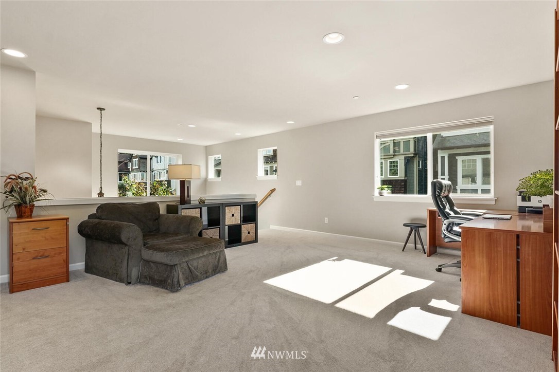 19622 94th Avenue Northeast, Unit 38 Bothell, WA 98011 - Photo 15 of 30 a living room with furniture and a dining table with kitchen view