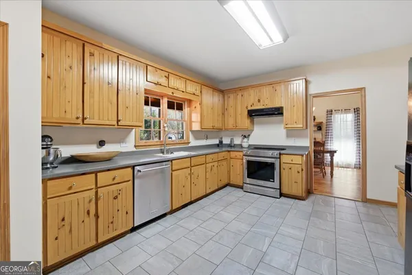 a living room with furniture a fireplace and wooden floor