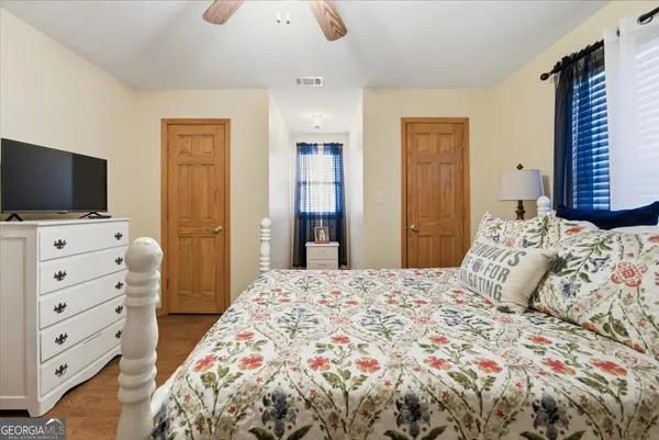 a view of a roof deck with table and chairs under an umbrella with wooden floor