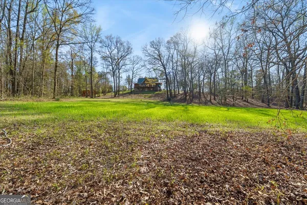 a porch with a bench next to yard