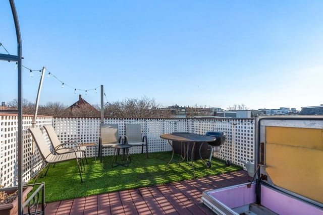 a view of a garden with sitting area