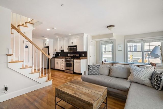 a living room with furniture kitchen and a stove