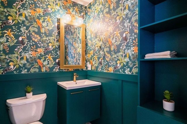 a bathroom with a toilet sink and mirror