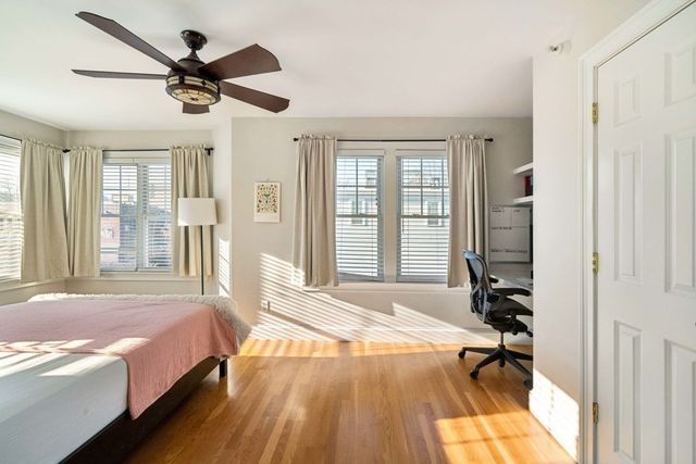 a spacious bedroom with a bed and a large window