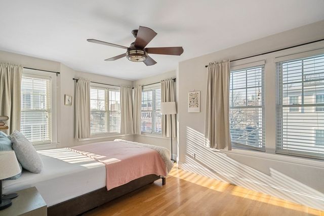 a spacious bedroom with a large bed and a large window