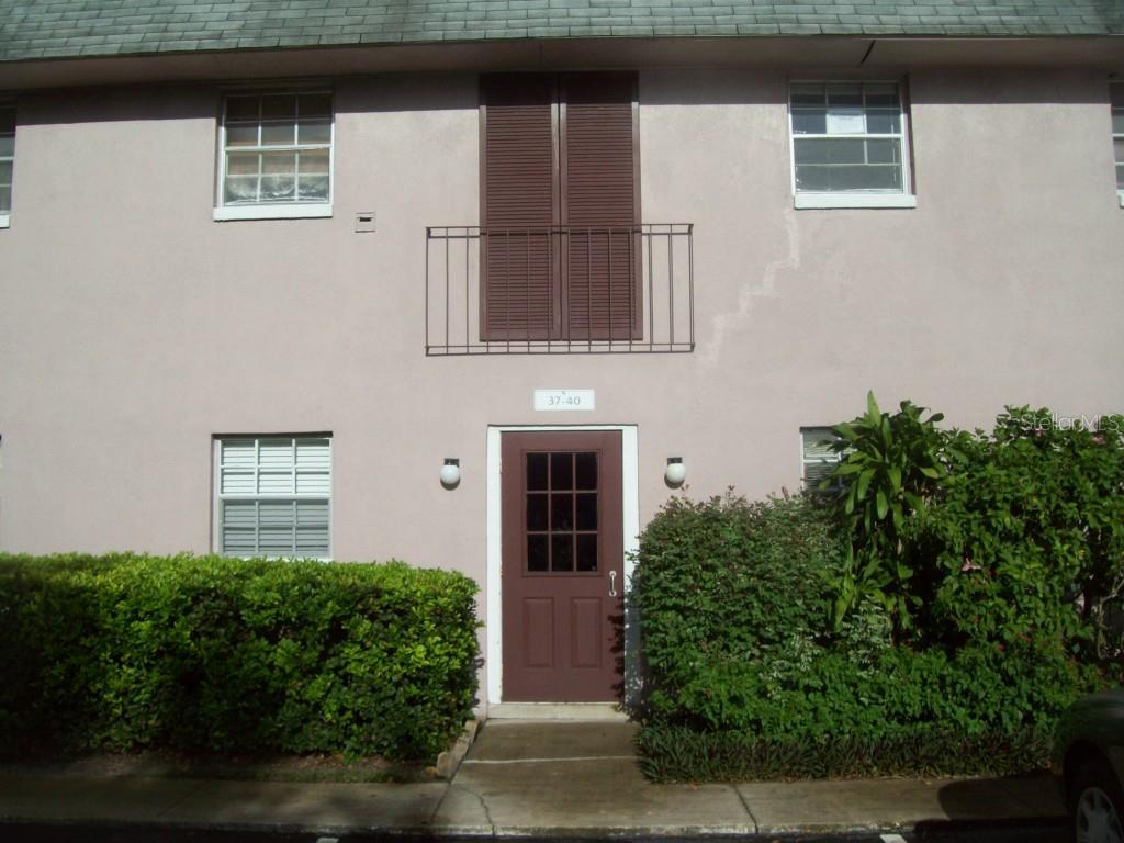 525 South Conway Road, Unit 390 Orlando, FL 32807 - Photo 1 of 1 a front view of a house with a yard