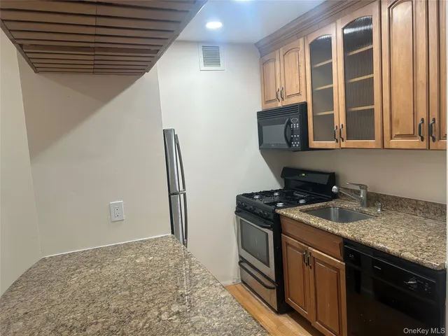 a kitchen that has a sink and a stove