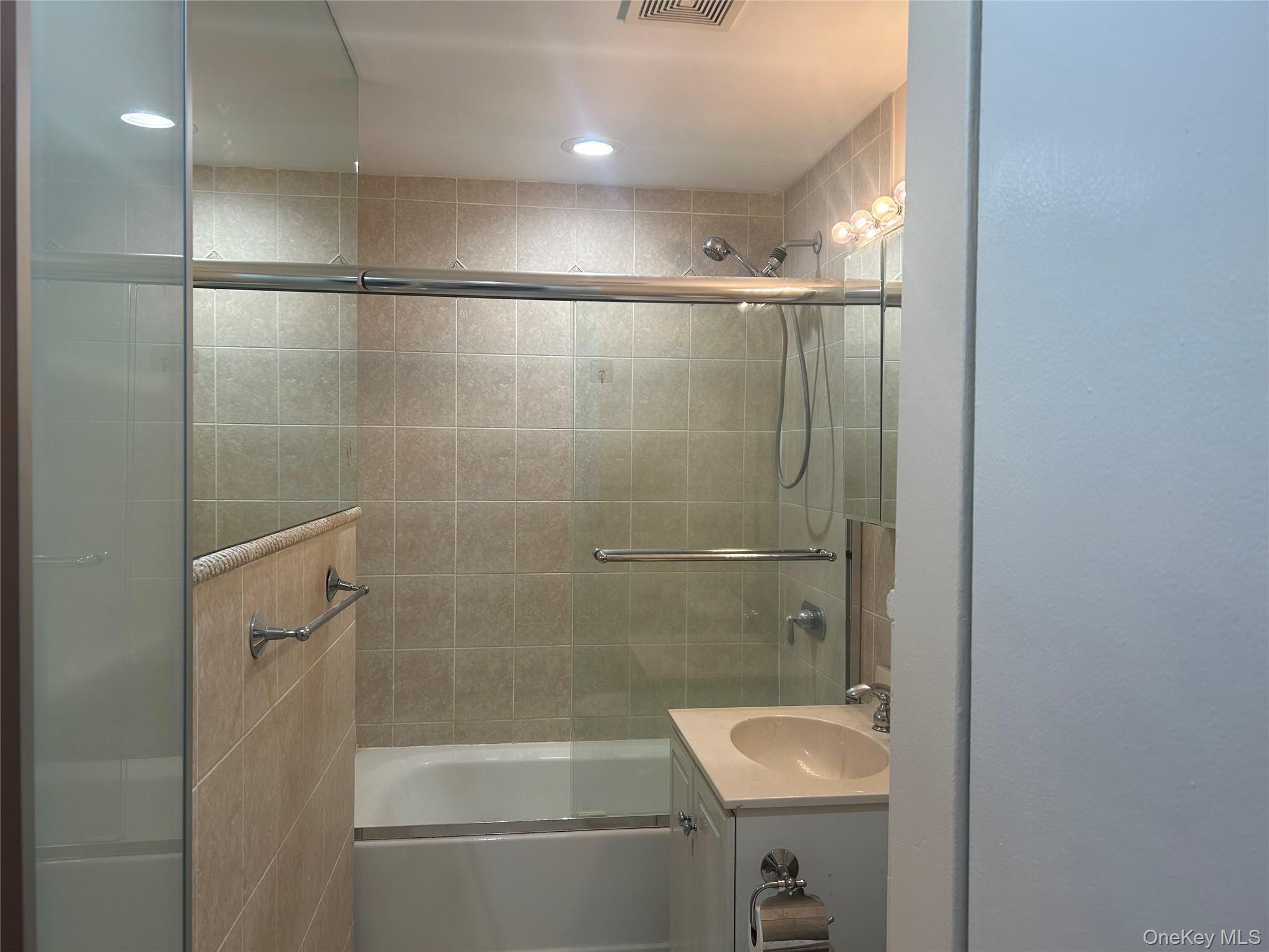 310 Riverside Boulevard, Unit 2C Long Beach, NY 11561 - Photo 15 of 21 a bathroom with a shower and a toilet