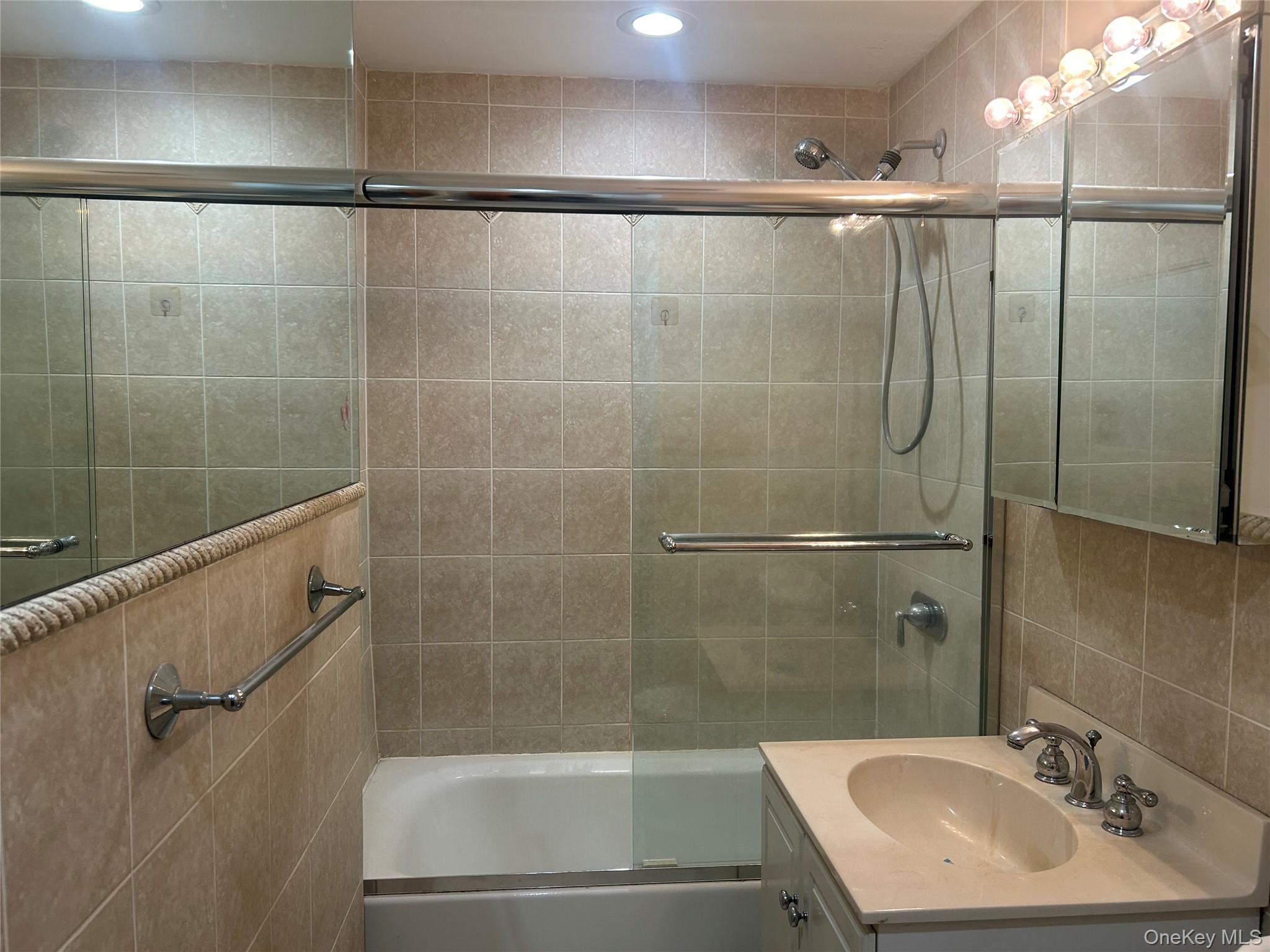 310 Riverside Boulevard, Unit 2C Long Beach, NY 11561 - Photo 16 of 21 a bathroom with a shower and a sink