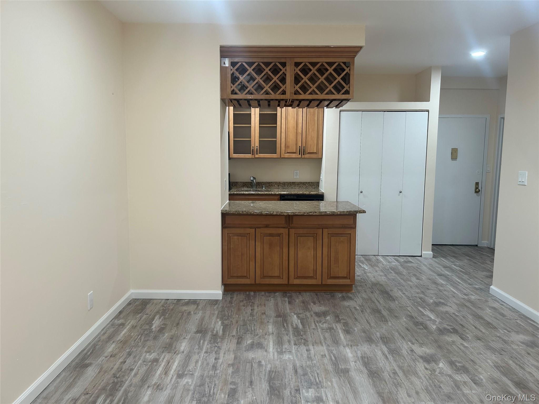 310 Riverside Boulevard, Unit 2C Long Beach, NY 11561 - Photo 10 of 21 a kitchen with a stove and a refrigerator