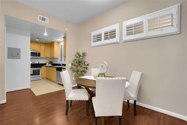 a view of a dining room with furniture and wooden floor