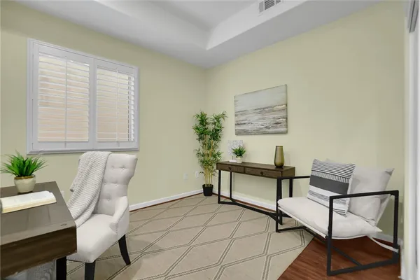 a living room with furniture and a potted plant