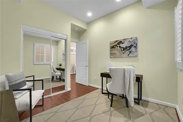 a view of a workspace with furniture and wooden floor
