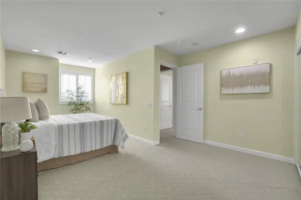 a spacious bedroom with a bed and a couch