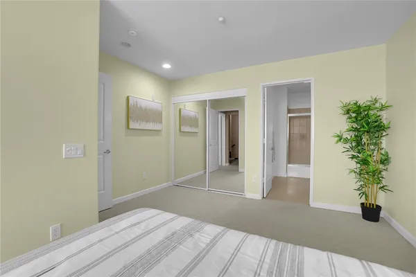 a view of empty room with wooden floor and potted plant