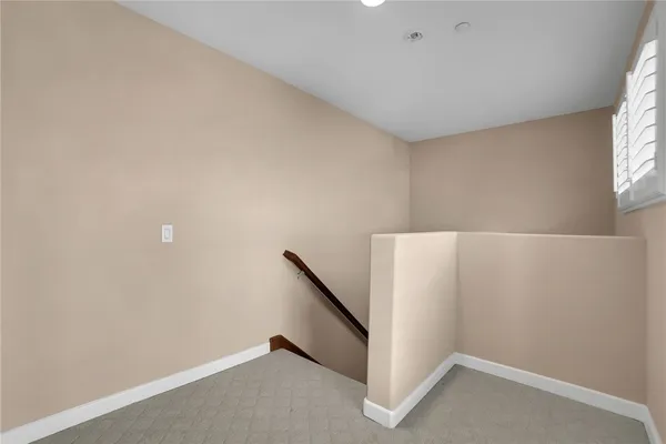 a view of an empty room with windows