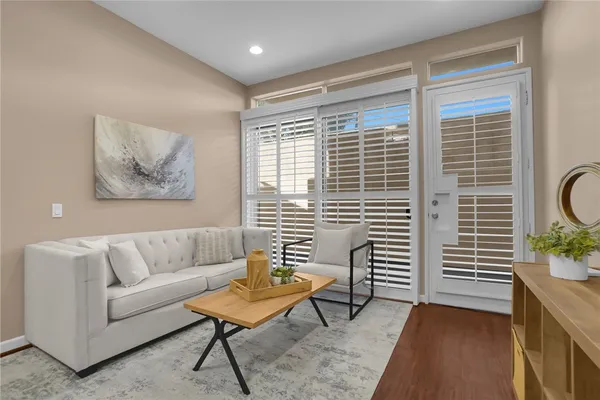 a living room with furniture and a potted plant