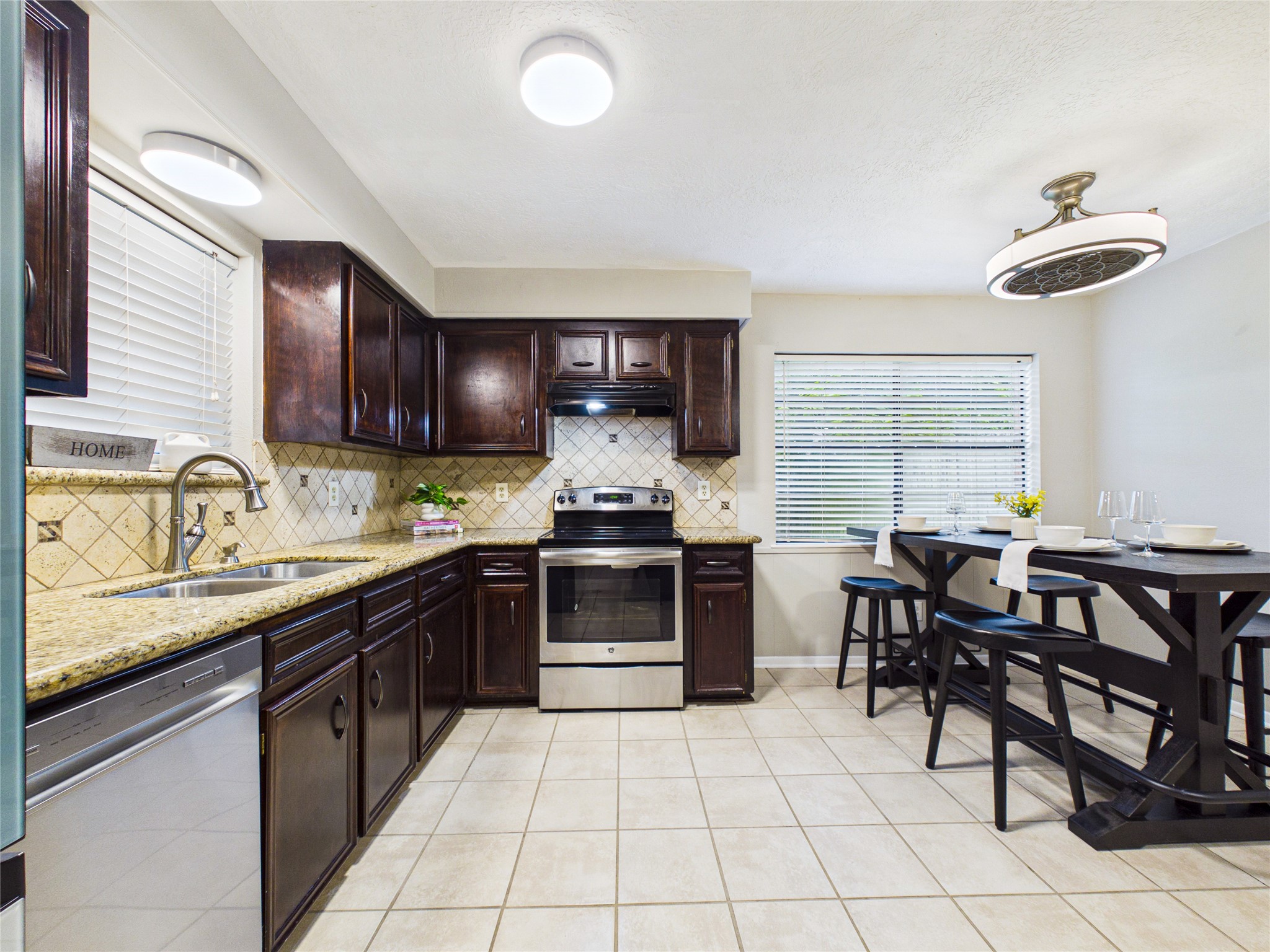 10306 Rustic Rock Road La Porte, TX 77571 - Photo 10 of 38 a kitchen with a sink and a stove top oven