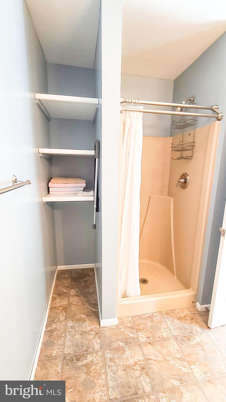 1531 Galena Road Baltimore, MD 21221 - Photo 25 of 66 Walk in shower and contemporary shelving.