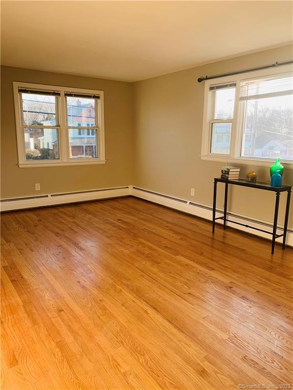 280 Lighthouse Road New Haven, CT 06512 - Photo 12 of 21 a view of an empty room with window and wooden floor