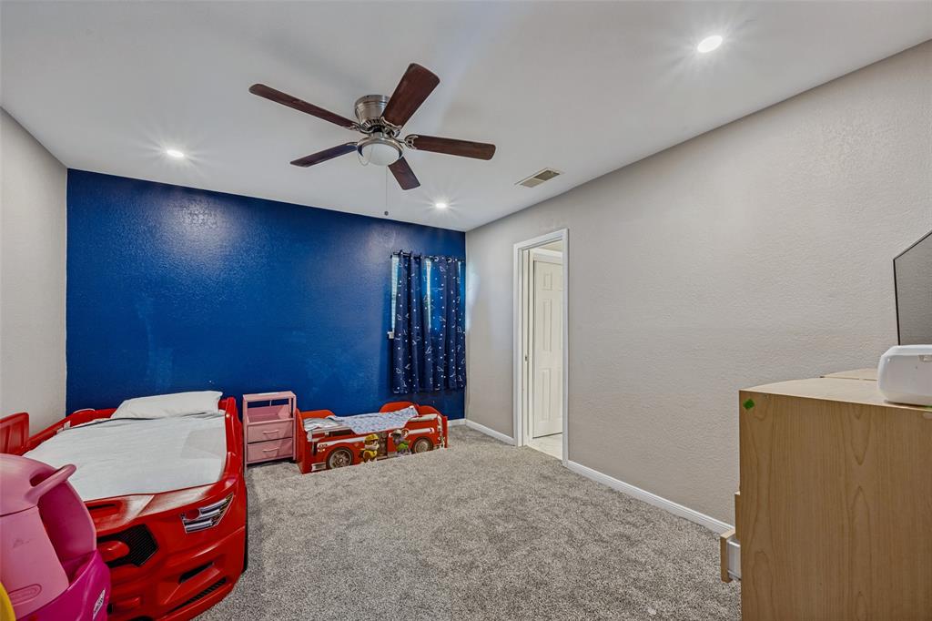 625 Caduceus Lane Hurst, TX 76053 - Photo 11 of 21 a blue bed sitting in a room next to a window