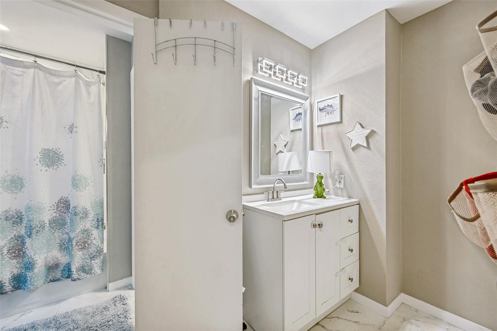 625 Caduceus Lane Hurst, TX 76053 - Photo 12 of 21 a bathroom with a sink a mirror and a shower