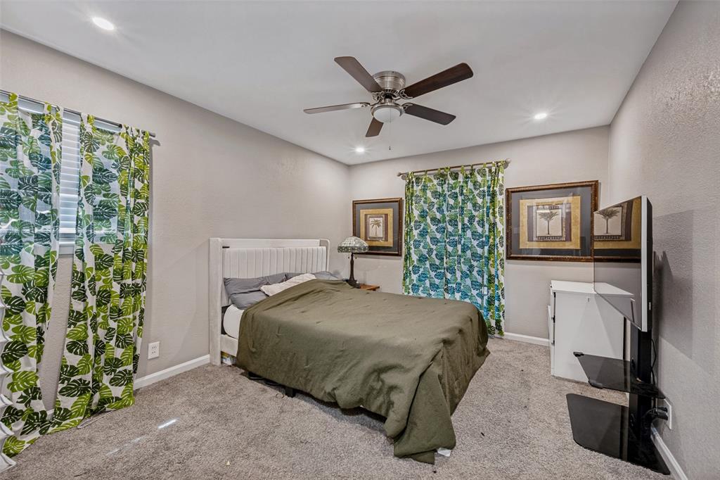 625 Caduceus Lane Hurst, TX 76053 - Photo 14 of 21 a bedroom with a bed a dresser and a window