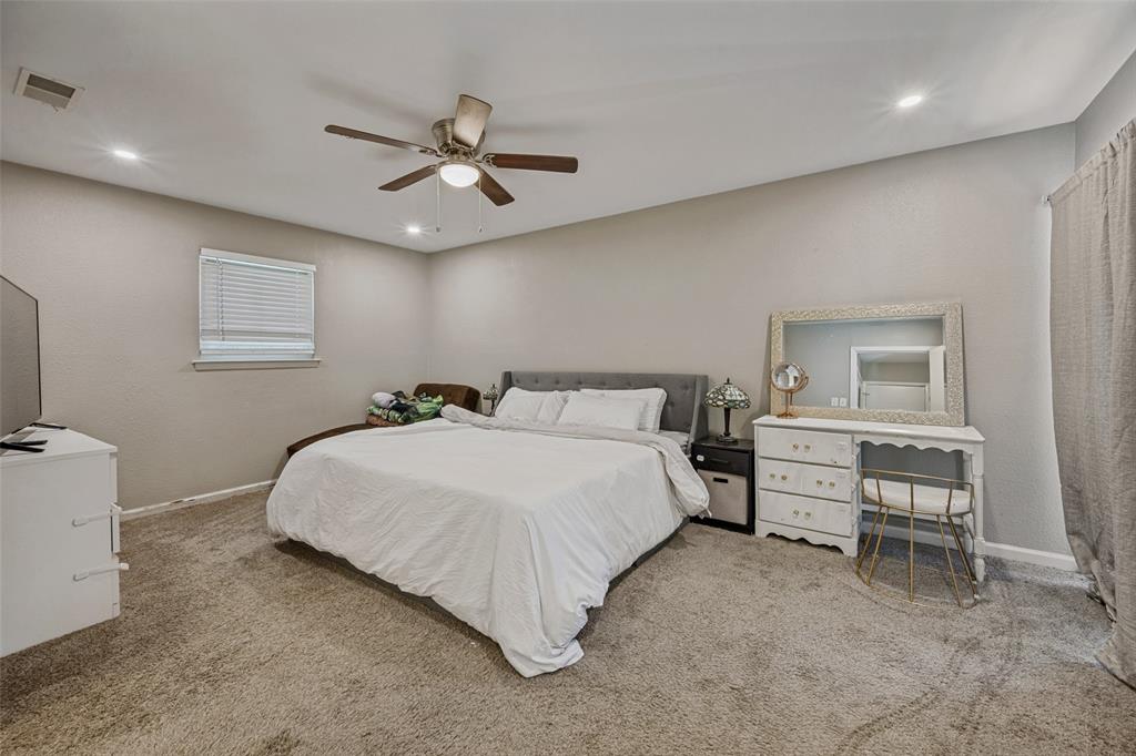 625 Caduceus Lane Hurst, TX 76053 - Photo 15 of 21 a bed room with a bed and a chandelier