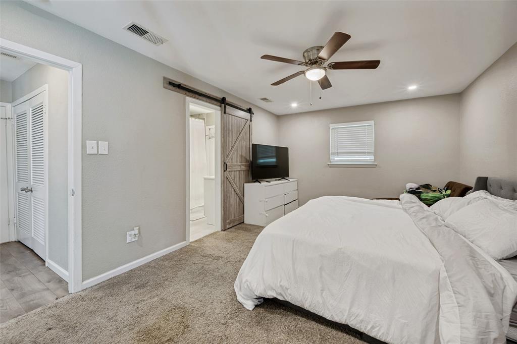 625 Caduceus Lane Hurst, TX 76053 - Photo 16 of 21 a spacious bedroom with a bed and a flat screen tv