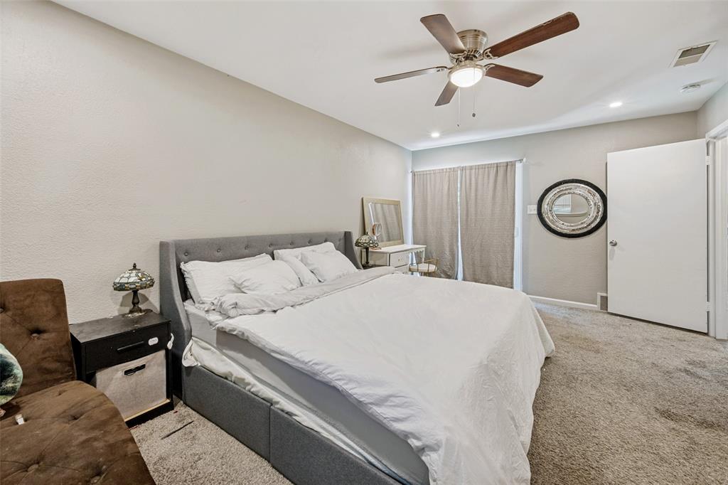625 Caduceus Lane Hurst, TX 76053 - Photo 17 of 21 a bedroom with a bed and a chandelier