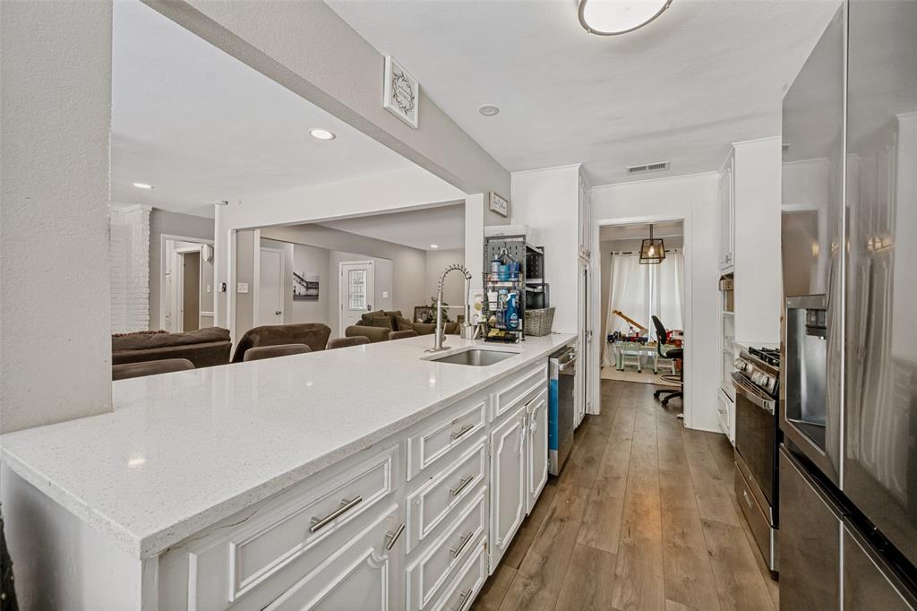 625 Caduceus Lane Hurst, TX 76053 - Photo 10 of 21 a large white kitchen with a large counter top appliances and cabinets