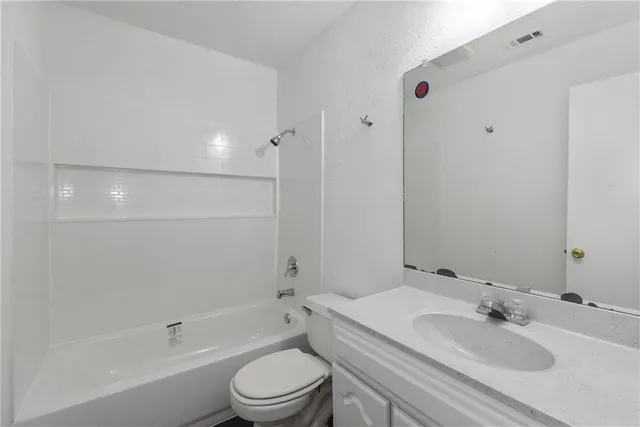 a bathroom with a toilet a sink and a bathtub