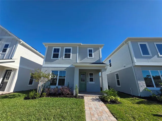 a front view of house with yard and green space