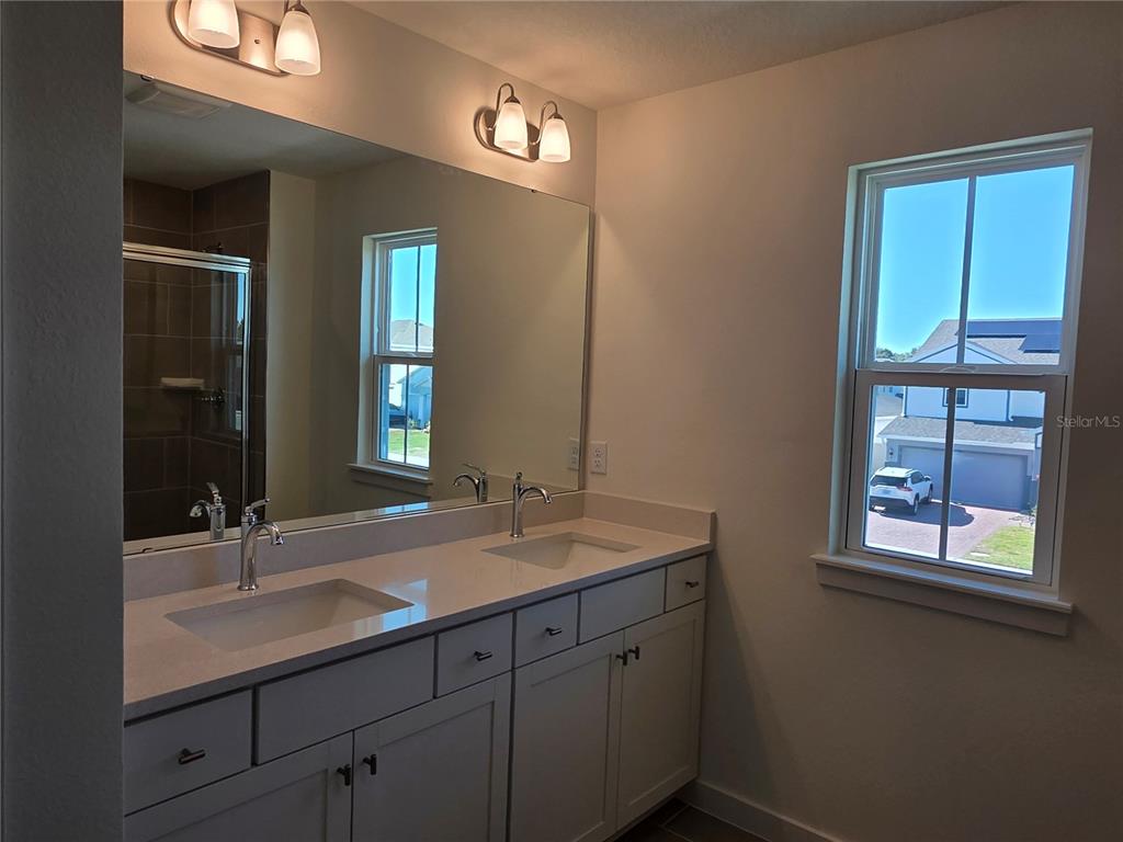 2047 Iorio Street St. Cloud, FL 34771 - Photo 13 of 17 a bathroom with a sink and two mirror