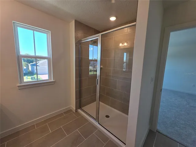 a bathroom with a glass shower door