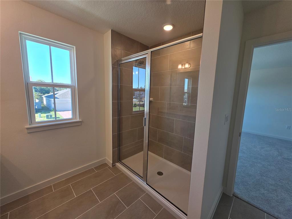 2047 Iorio Street St. Cloud, FL 34771 - Photo 14 of 17 a bathroom with a glass shower door