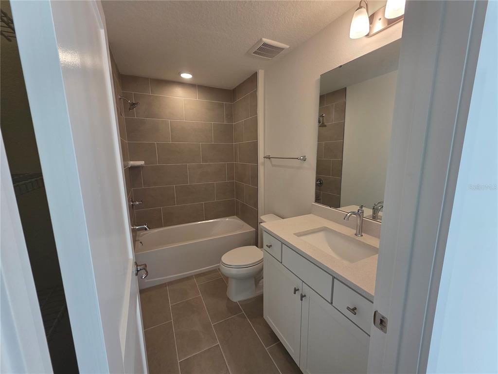 2047 Iorio Street St. Cloud, FL 34771 - Photo 15 of 17 a bathroom with a granite countertop sink toilet and shower