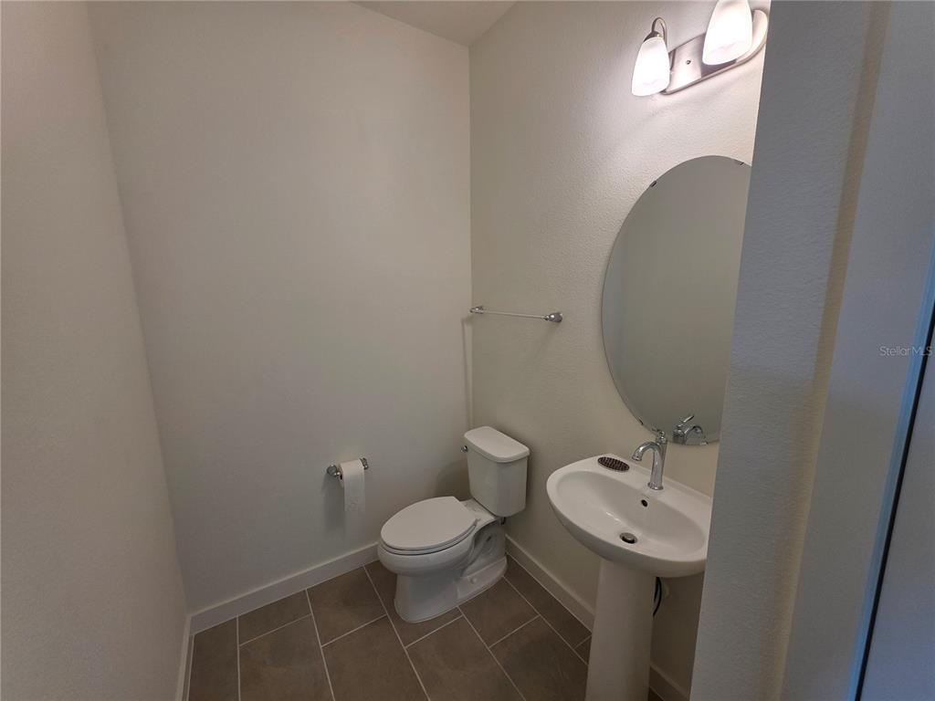 2047 Iorio Street St. Cloud, FL 34771 - Photo 16 of 17 a bathroom with a toilet sink and mirror
