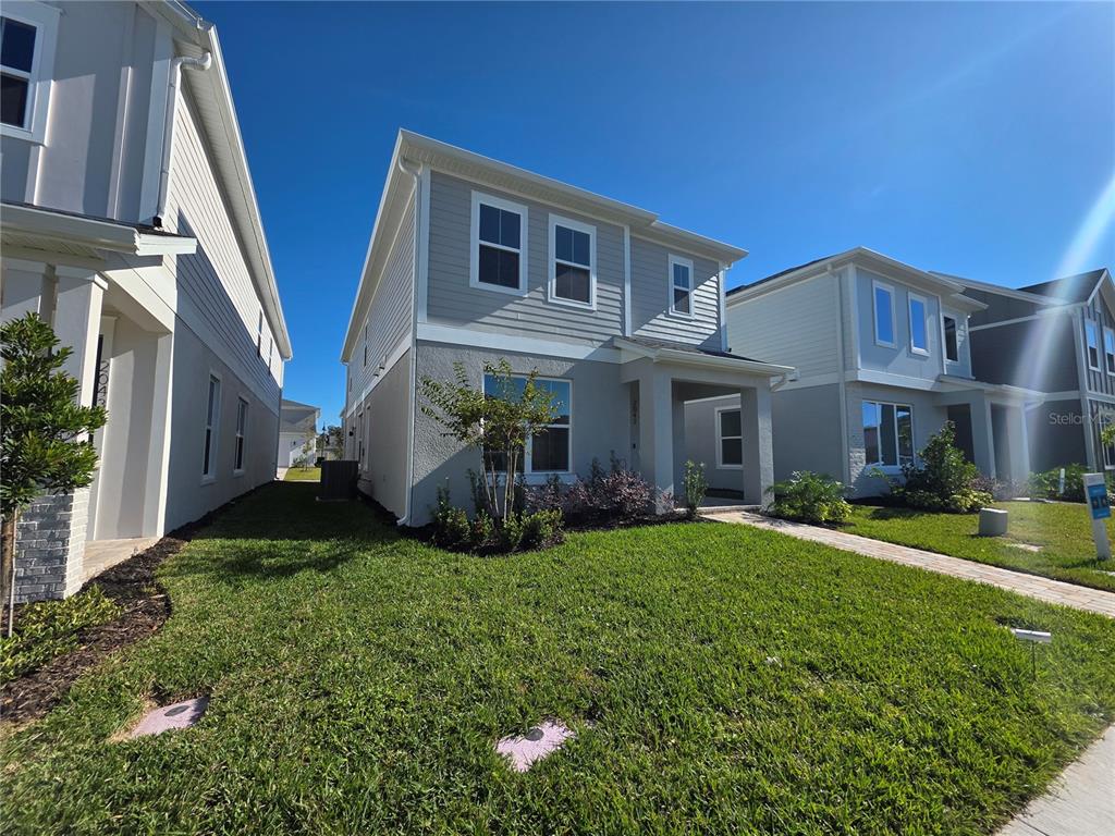 2047 Iorio Street St. Cloud, FL 34771 - Photo 2 of 17 a front view of a house with a yard