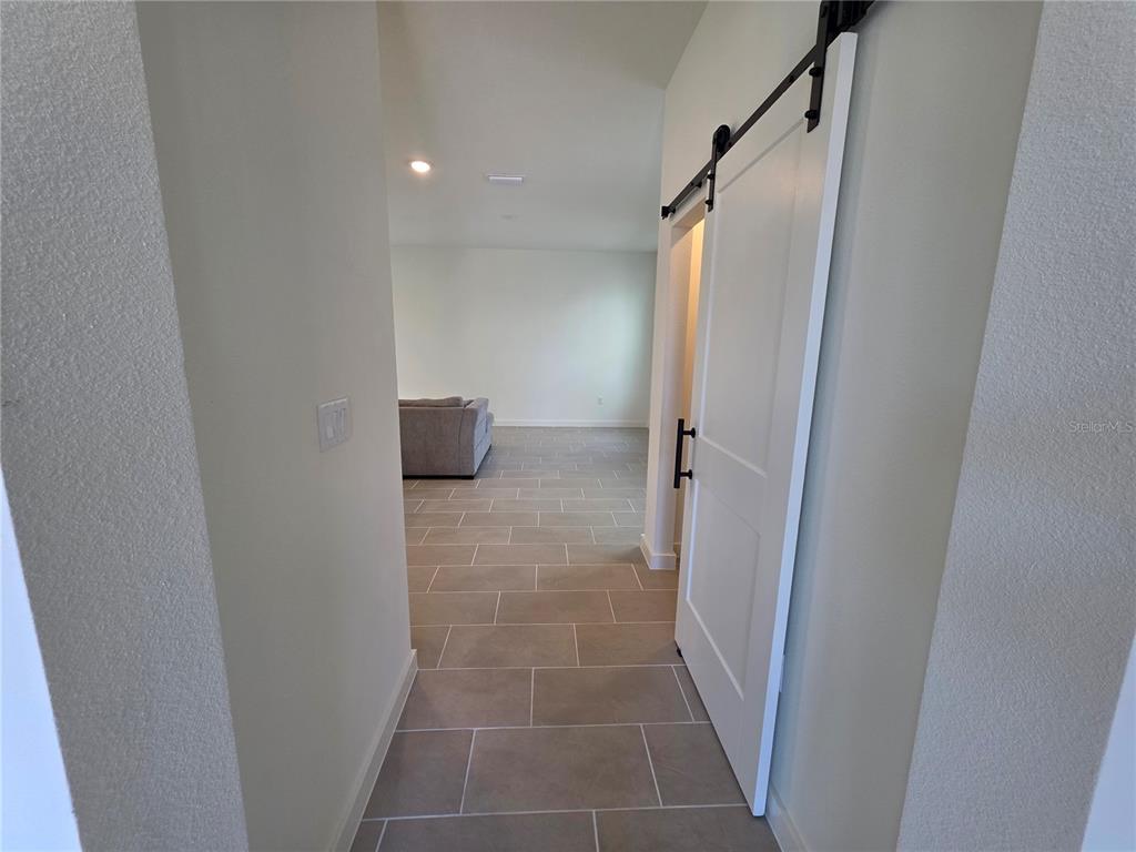 2047 Iorio Street St. Cloud, FL 34771 - Photo 7 of 17 a bathroom with a glass door shower and a sink