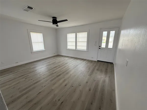 wooden floor in an empty room with a window