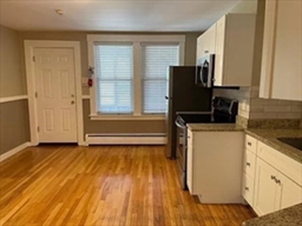333 Oak Hill Road, Unit 2R Fitchburg, MA 01420 - Photo 2 of 12 a view of a kitchen with wooden floor and a sink
