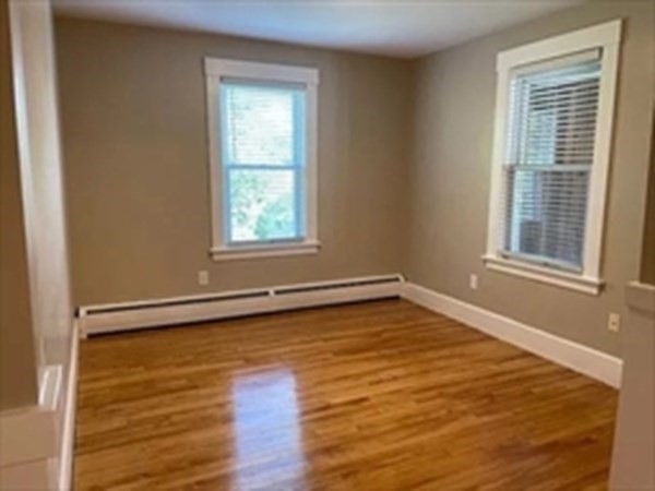 333 Oak Hill Road, Unit 2R Fitchburg, MA 01420 - Photo 8 of 12 a view of an empty room with wooden floor and a window